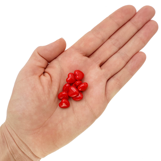10mm red heart shaped beads in a hand on a white background