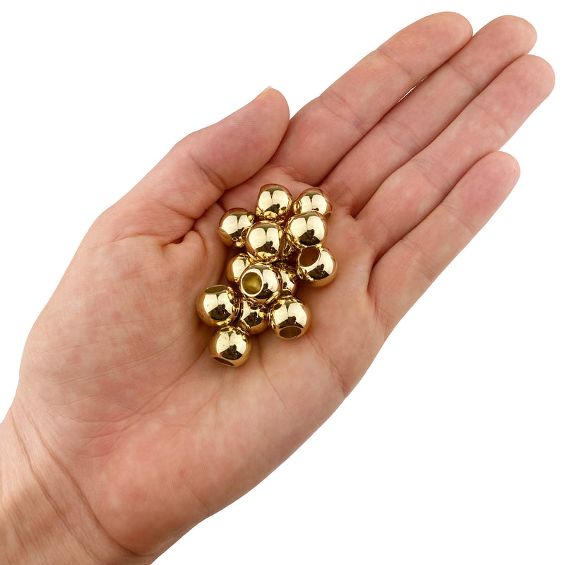 Acrylic Large Hole Beads for Crafts 10mm x 12mm Acrylic Barrel Beads with 5.7mm Large Hole, Shiny Gold shown in a hand on a white background