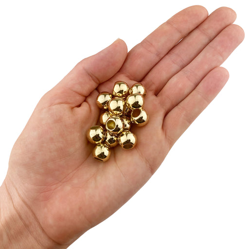 Acrylic Large Hole Beads for Crafts 10mm x 12mm Acrylic Barrel Beads with 5.7mm Large Hole, Shiny Gold shown in a hand on a white background